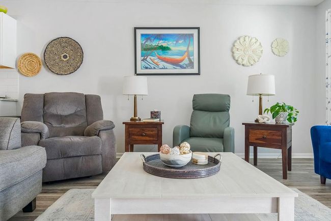 Living area featuring baseboards and wood finished floors | Image 8