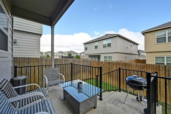 Fenced backyard with a residential view and a grill | Image 15