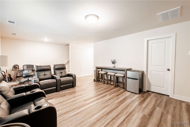 Home theater with light wood-type flooring and baseboards | Image 36