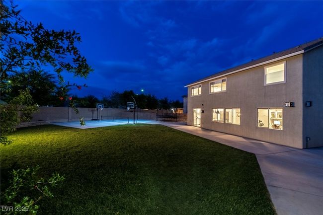 Yard at night featuring a patio and a fenced backyard | Image 50