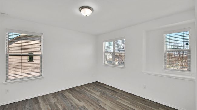 Unfurnished room with dark wood-style floors and baseboards | Image 31