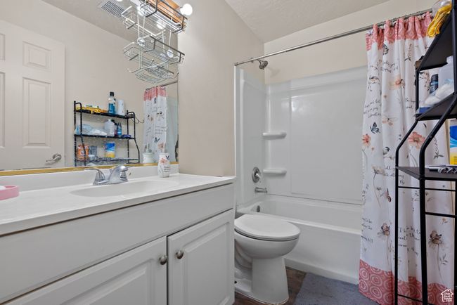 Bathroom featuring vanity and shower / tub combo with curtain | Image 54