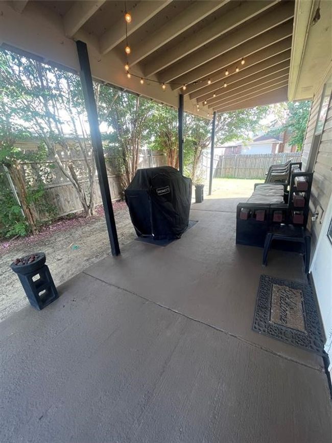 Fenced backyard with area for grilling and a patio area | Image 24