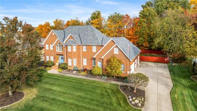 View of front facade featuring a front lawn and a garage | Image 1