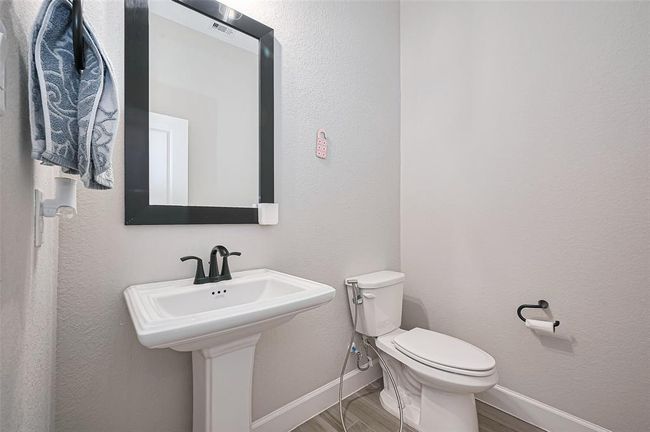 The conveniently located powder room offers a stylish and private space for guests, with a clean design blend seamlessly | Image 14