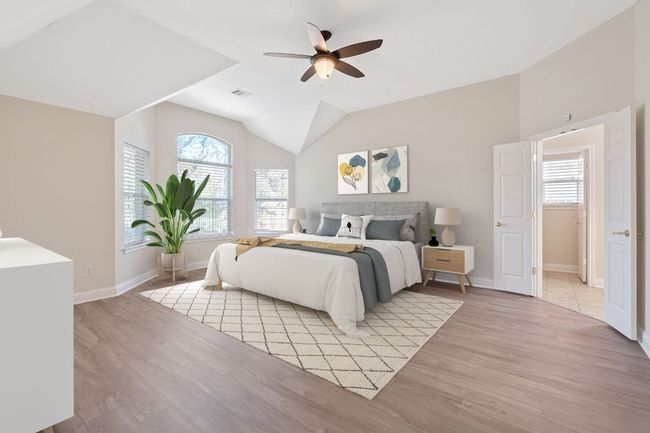 Bedroom featuring visible vents, baseboards, a ceiling fan, lofted ceiling, and light wood-type flooring | Image 5