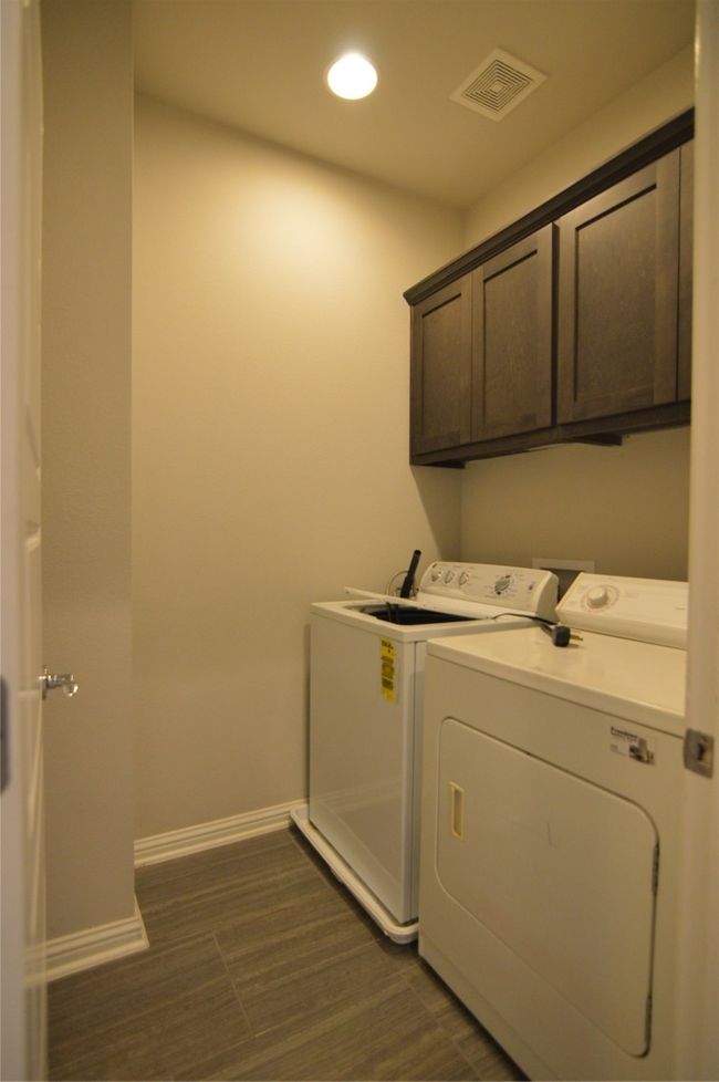 Laundry room with washing machine and clothes dryer, cabinet space, baseboards, and recessed lighting | Image 14