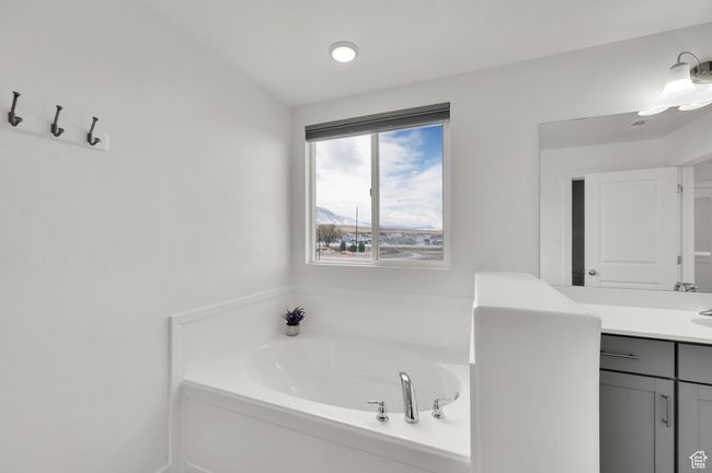 Bathroom featuring vanity and a garden tub | Image 15