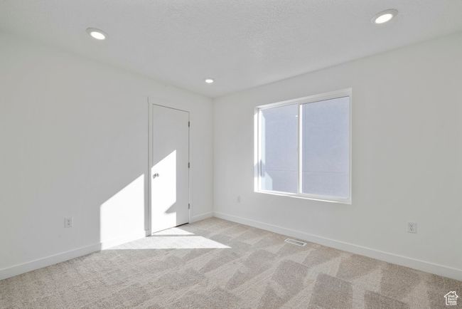 This light-filled bedroom is a blank slate for guests, kids, or a home office setup. | Image 15