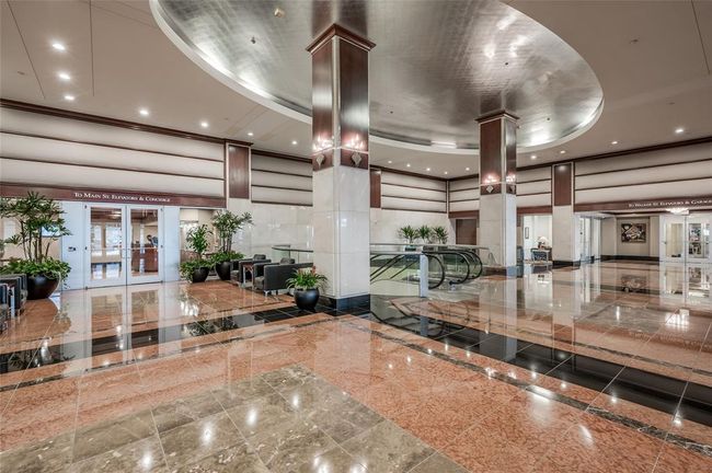 The Building Lobby of 914 Main shows the escalators leading down to Downtown's 7 mile tunnel system, connecting you to most of Downtown's major buildings. The tunnels have restaurants, shops & more! Through the secured double doors seen to left is Commerce Tower's Resident’s Lobby with concierge! | Image 25