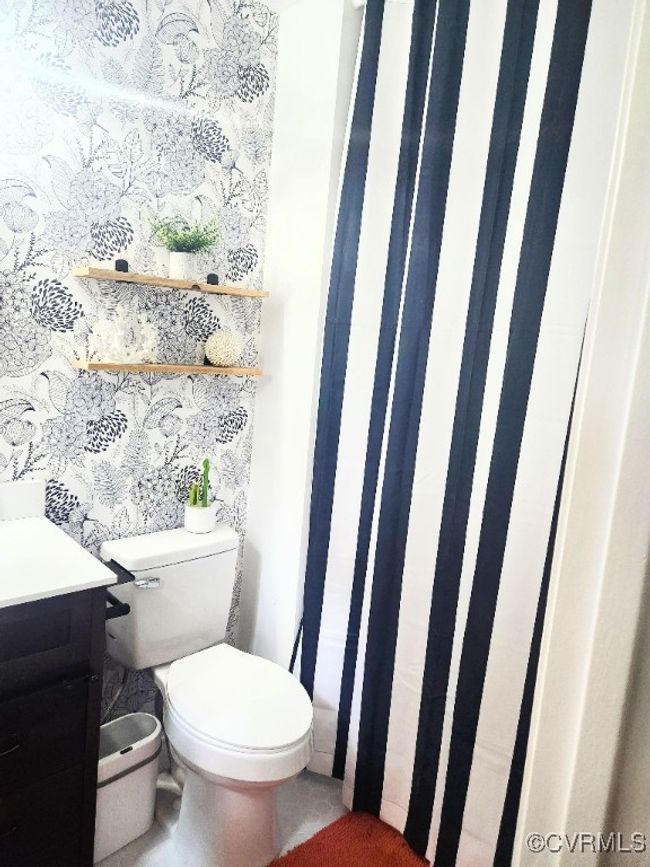 Bathroom featuring curtained shower and vanity | Image 21