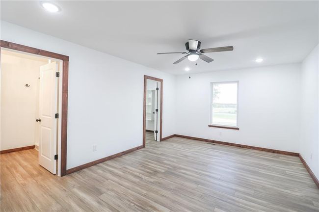 Empty room with ceiling fan and light hardwood / wood-style flooring | Image 23