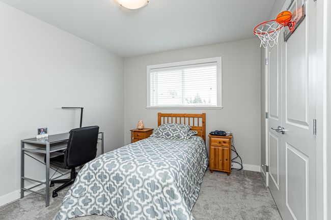 Bedroom with carpet floors and baseboards | Image 8