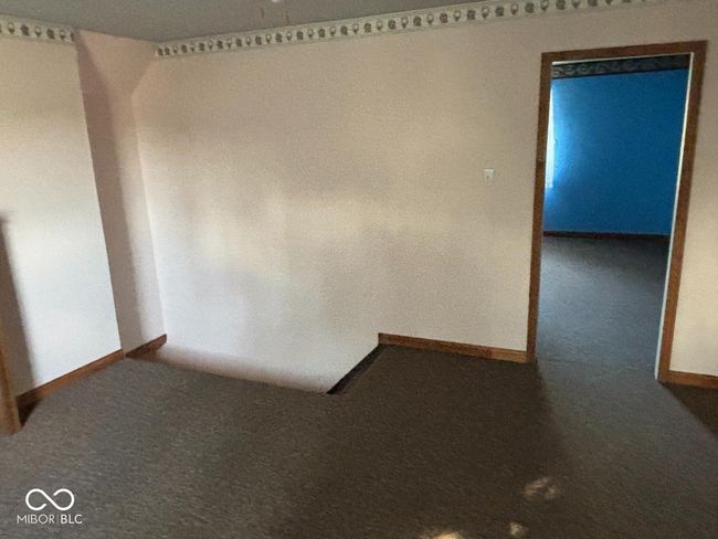 spare room featuring baseboards and carpet | Image 8