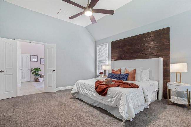 Carpeted bedroom with lofted ceiling, a ceiling fan, and baseboards | Image 18
