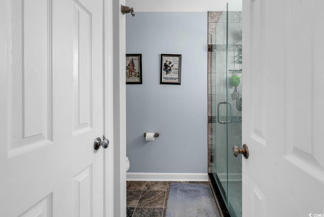 Bathroom featuring a shower stall, baseboards, and toilet | Image 22