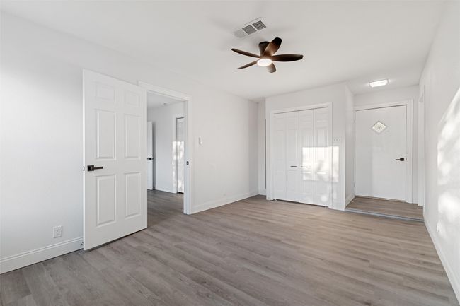 Unfurnished bedroom featuring light hardwood / wood-style flooring and ceiling fan | Image 28