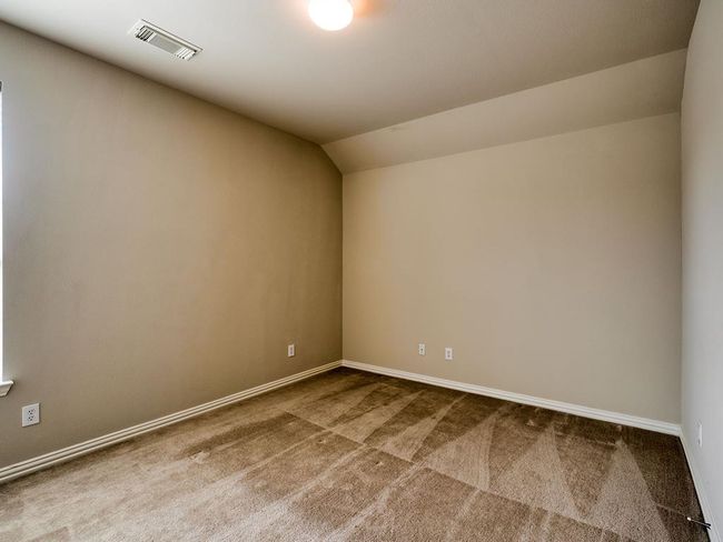 Carpeted spare room with vaulted ceiling and baseboards | Image 36