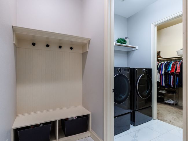 The laundry room includes built-in storage space and W/D connections. | Image 28