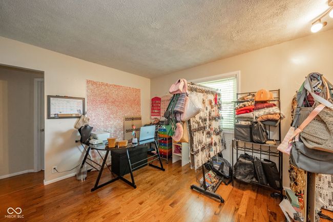miscellaneous room with a textured ceiling and wood finished floors | Image 27