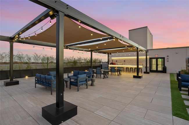 View of patio featuring an outdoor hangout area | Image 11