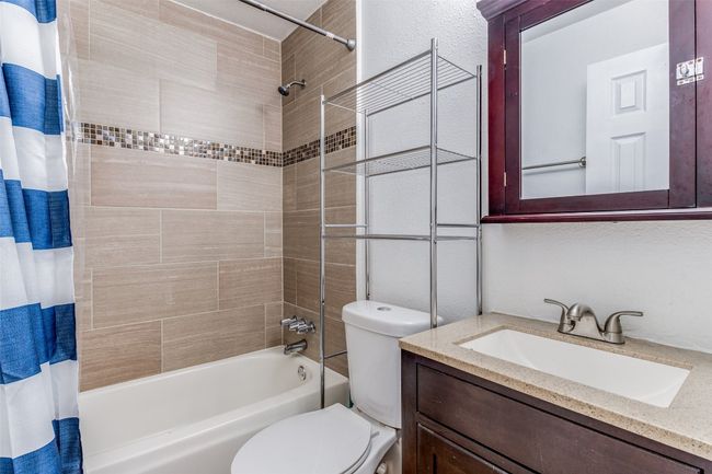 Bathroom featuring shower / tub combo, toilet, and vanity | Image 8