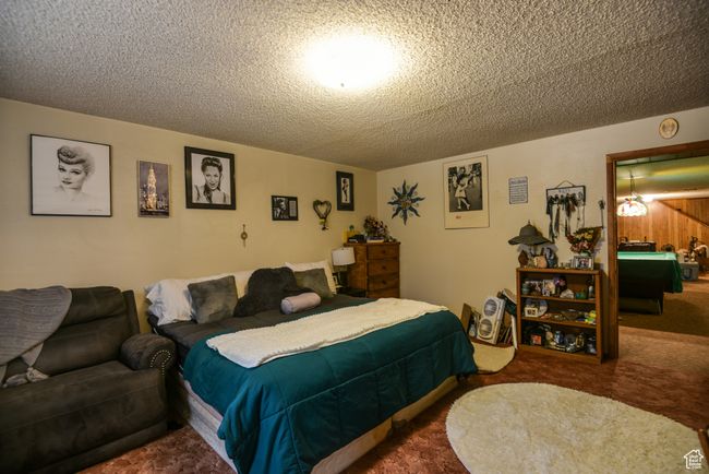 Bedroom featuring a textured ceiling and carpet floors | Image 15