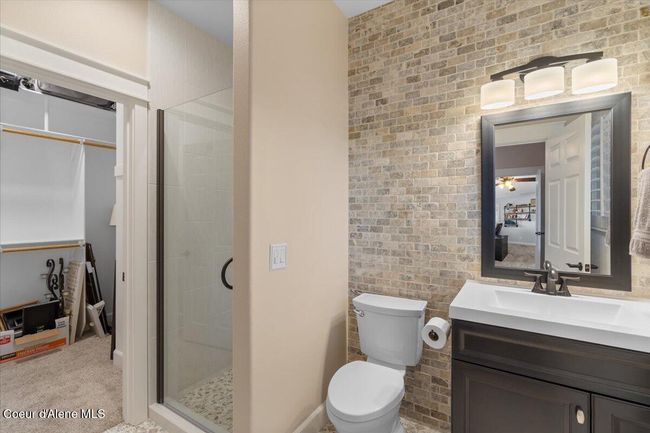 Main level primary bathroom with walk-in closet. | Image 23