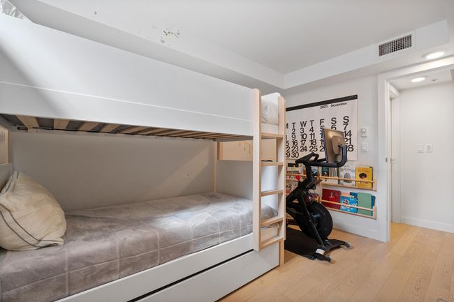 Bedroom featuring visible vents and wood finished floors | Image 22