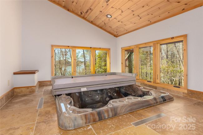 Spa house features a sunken hot tub that blends seamlessly with its tranquil surroundings. | Image 38
