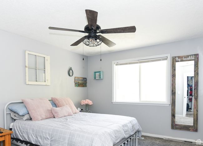 Bedroom with a ceiling fan, carpet flooring, and baseboards | Image 24