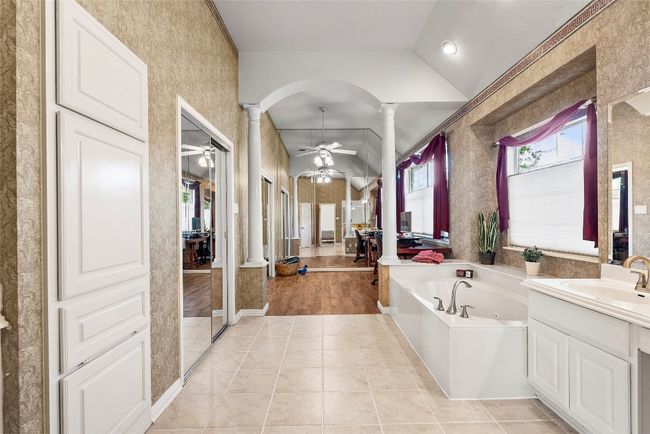 The ensuite bath is a spa-like haven, featuring a step-in shower, perfect for unwinding after a long day | Image 21