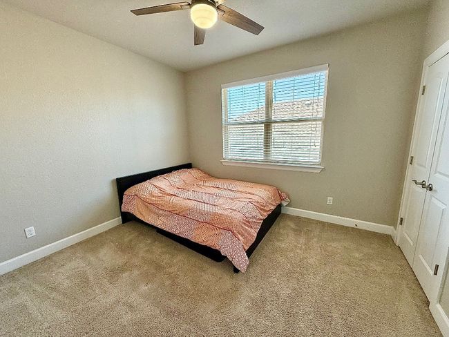 Bedroom featuring carpet floors, baseboards, and a ceiling fan | Image 29