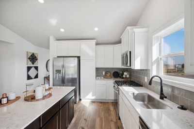 (*Photo of decorated model, actual homes colors and finishes will vary) Modern and functional, the kitchen is sure to impress. | Image 3