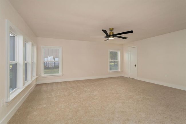 The primary bedroom is a spacious retreat featuring plush carpeting, a spacious walk-in closet, and an en-suite bathroom with tasteful finishes. | Image 18