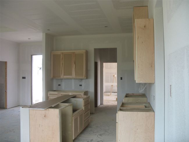 Kitchen with light brown cabinetry and a center island | Image 12