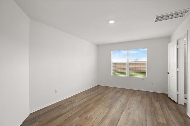 Unfurnished bedroom with light wood-style flooring, baseboards, and recessed lighting | Image 14
