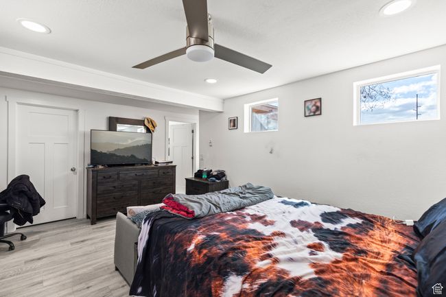 Bedroom with light wood-style flooring, multiple windows, recessed lighting, and a ceiling fan | Image 13