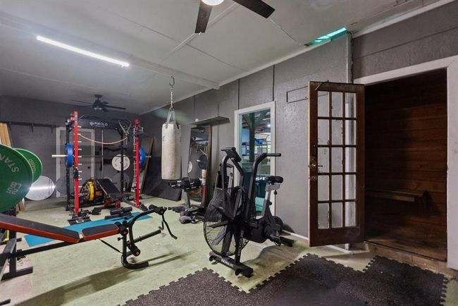 Fully equipped home gym in the shop with attached cedar sauna for your wellness routine. | Image 49