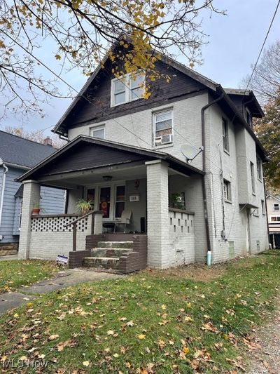 View of front property featuring a front lawn and a porch | Image 1