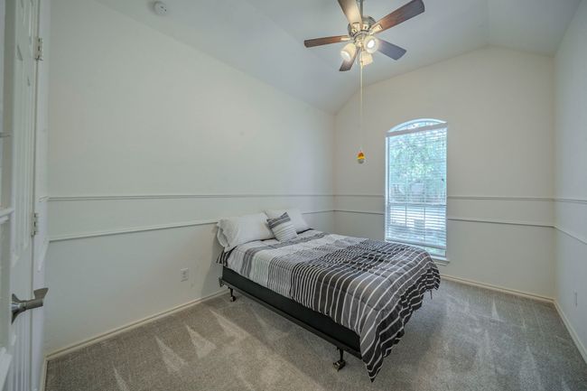 Bedroom with lofted ceiling, carpet floors, and a ceiling fan | Image 20
