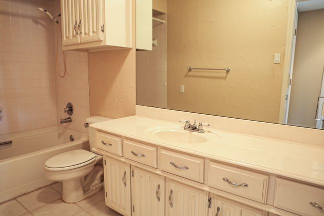 Bathroom featuring vanity, washtub / shower combination, and tile patterned floors | Image 10