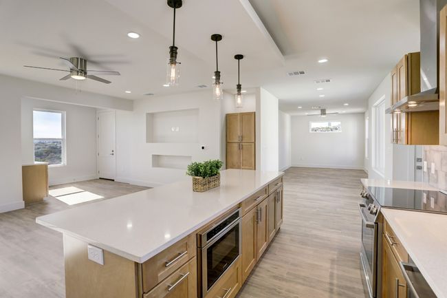 #931 with dark cabinets and walls removed between living room and office and a bedroom wall removed. | Image 31