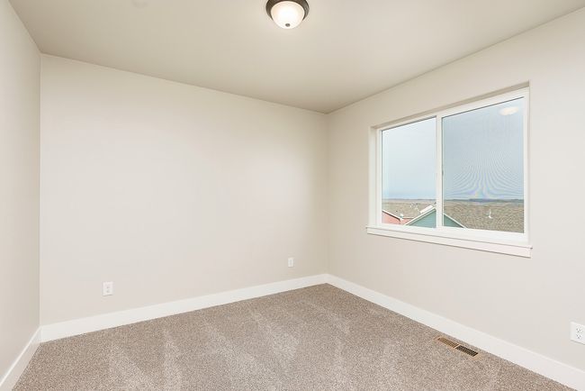 Carpeted empty room featuring visible vents and baseboards | Image 13
