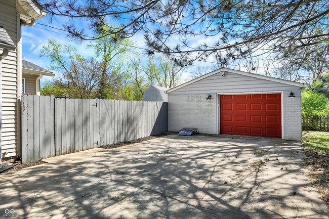 detached garage with driveway and fence | Image 44