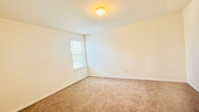 Empty room featuring light colored carpet and baseboards | Image 32