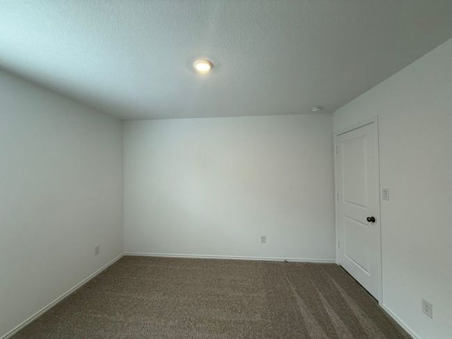 Spare room with dark carpet, baseboards, and a textured ceiling | Image 24