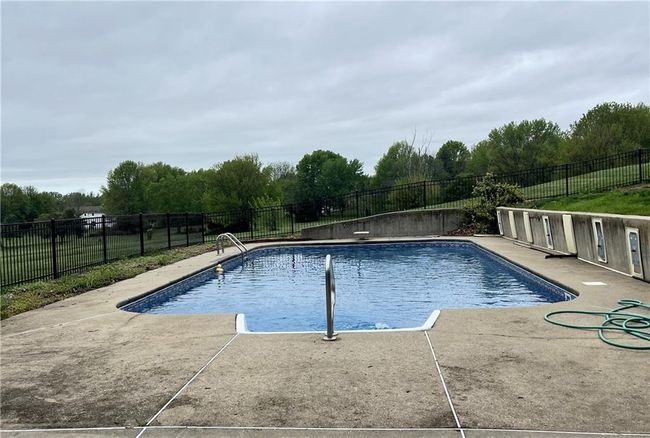 View of swimming pool featuring a fenced in pool, a patio area, and fence | Image 42
