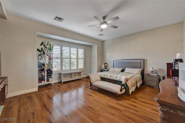 Bedroom featuring wood finished floors and a ceiling fan | Image 37