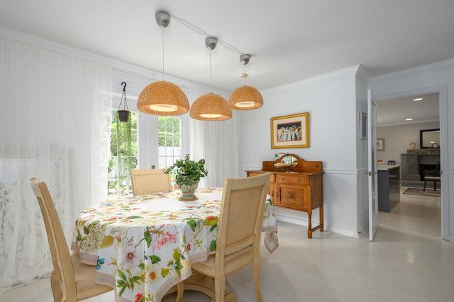 Dining area with crown molding and light wood finished floors | Image 6